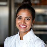 Chef Anya Patel, Culinary Development Lead, smiling warmly.